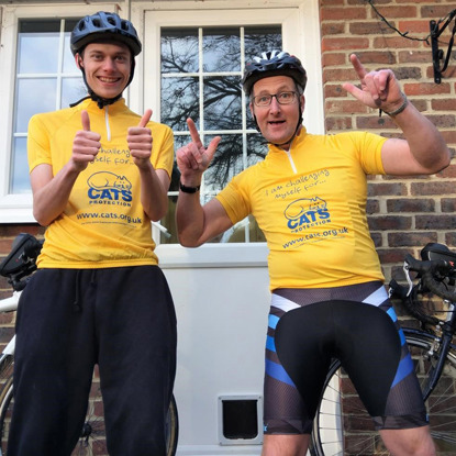 two men wearing Cats Protection cycling tops