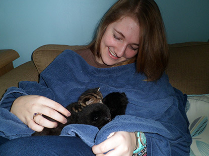 young woman with kittens on her lap