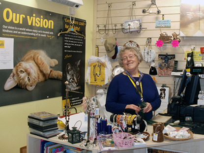 woman behind cash till at Cats Protection charity shop