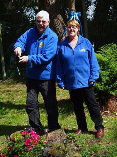 Two gardening volunteers in a Cats Protection garden