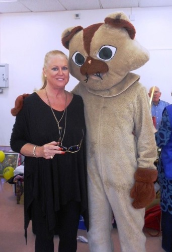 brown cat mascot with Kim Woodburn