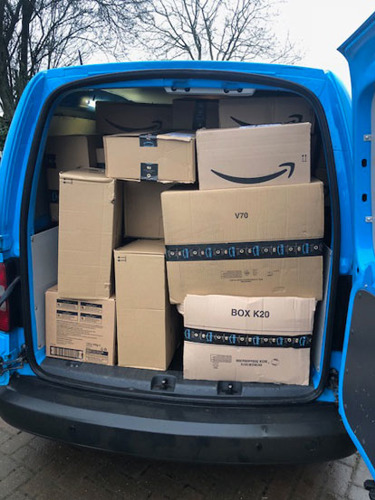 van full of Amazon parcels
