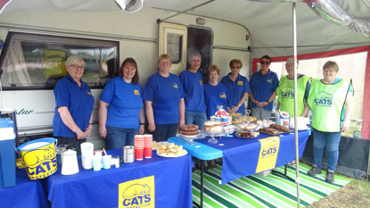 Cats Protection fundraisers in blue t-shorts with afternoon tea stalls