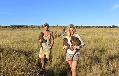 Carley Stenson and Danny Mac with monkeys in Africa