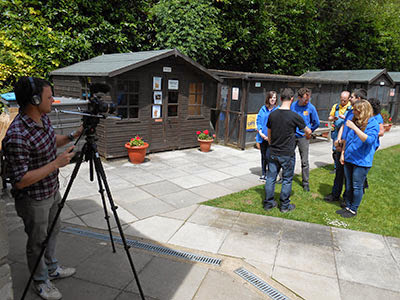 camera crew with Cats Protection staff in garden