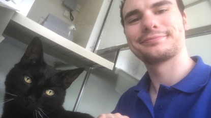 Cat care volunteer with black cat