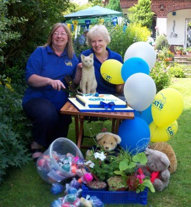 Cats Protection volunteers with stall and balloons