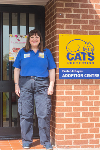 woman in front of Cats Protection Exeter Axhayes Adoption Centre sign
