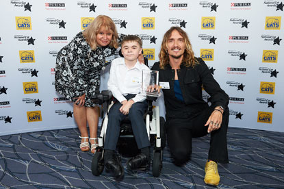 Winner of the Furr-ever Friends Award (Salem) Jared Bignold and his mother Verity with and Justin Hawkins at the 2018 National Cat Awards